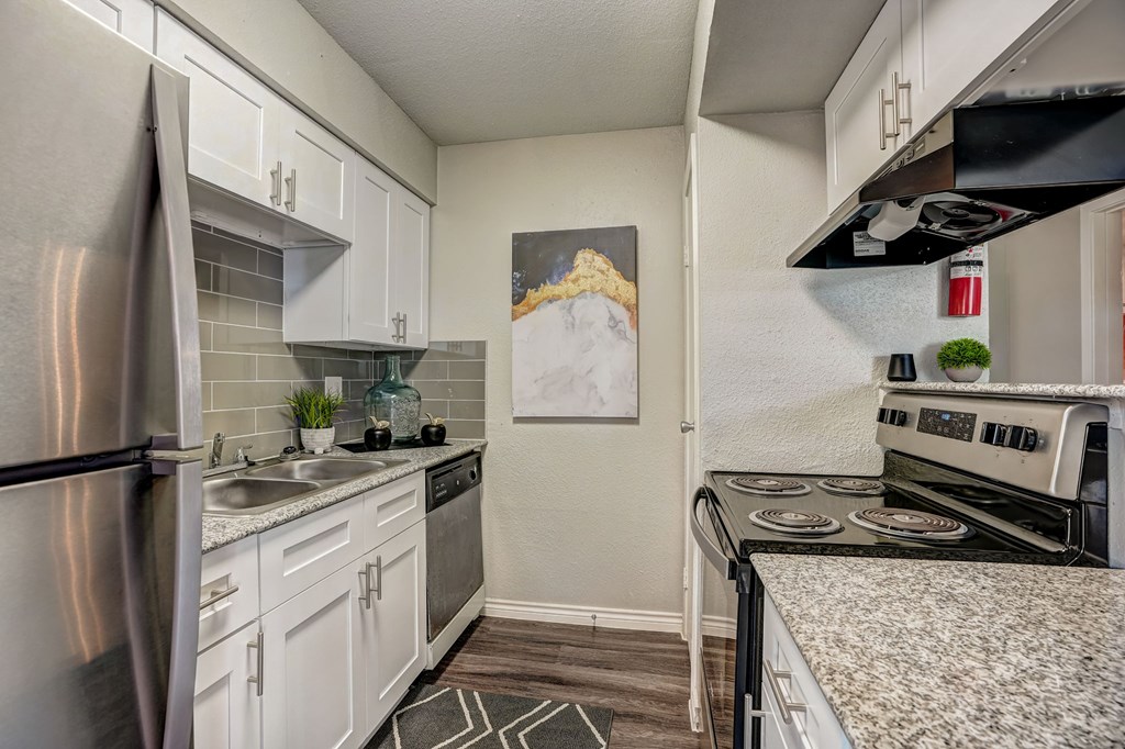 a kitchen with stainless steel appliances and granite counter tops
