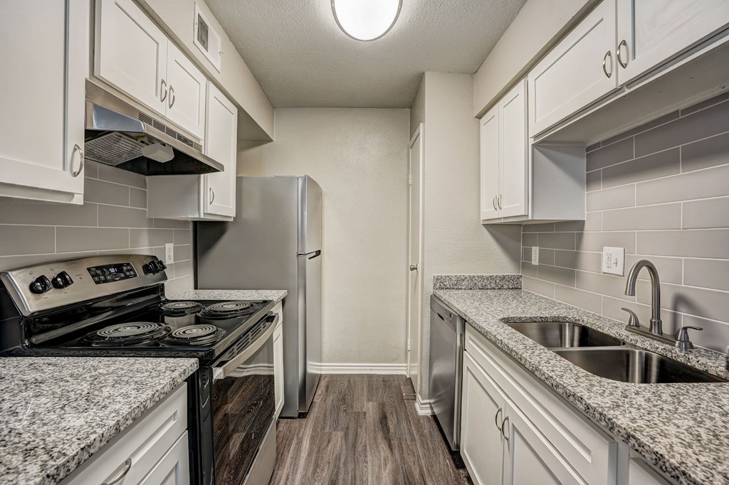 a small kitchen with white cabinets and a black and white rendering of a counter top