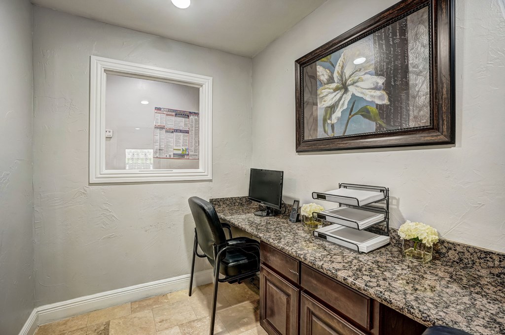a home office with a desk and a window