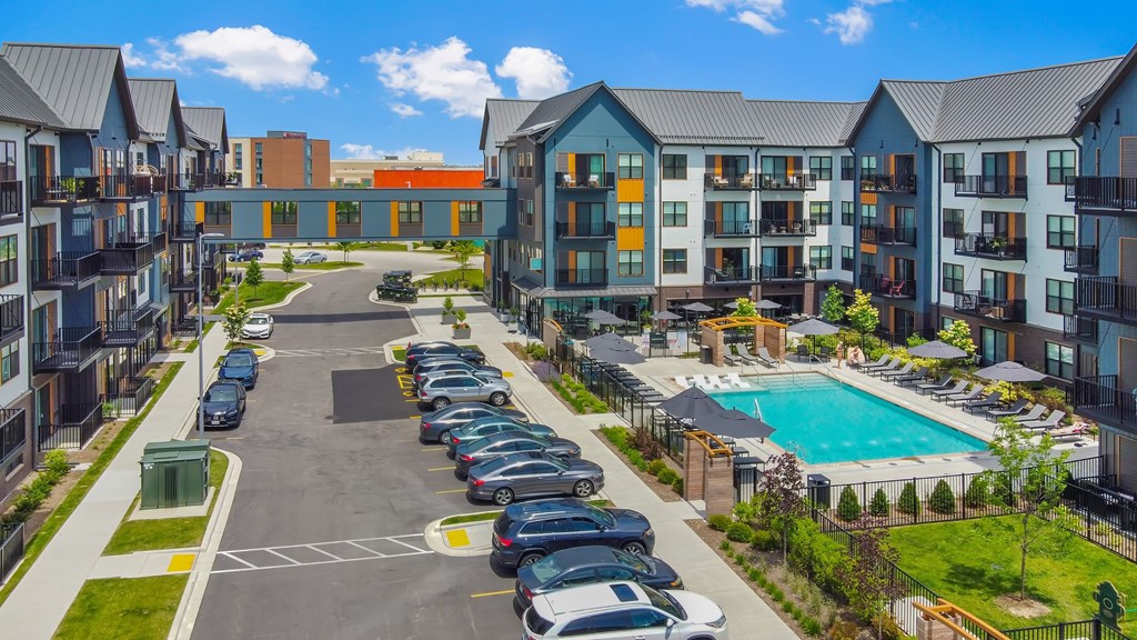 an aerial view of an apartment building with a swimming pool