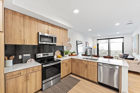 A modern kitchen with wooden cabinets and stainless steel appliances.