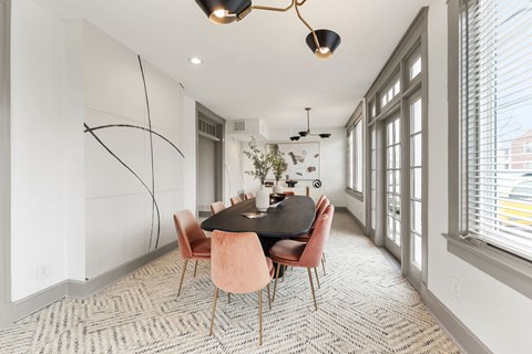 A dining room with a table and chairs.