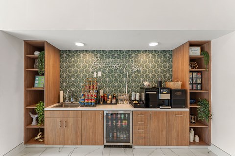 A kitchen with wooden cabinets and a green patterned backsplash.