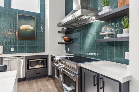 A modern kitchen with a stainless steel oven and a white countertop.