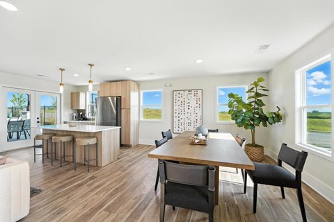 A modern kitchen with a dining table and chairs.