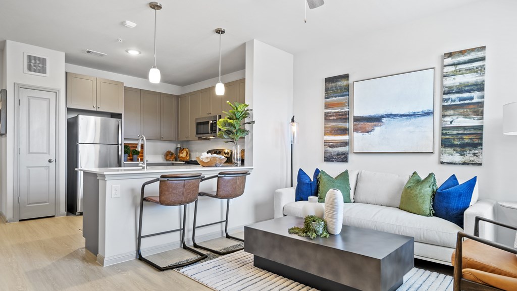 a living room with a kitchen and a couch and a table