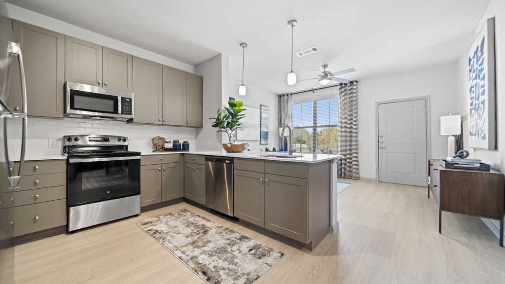 a spacious kitchen with stainless steel appliances and a large island