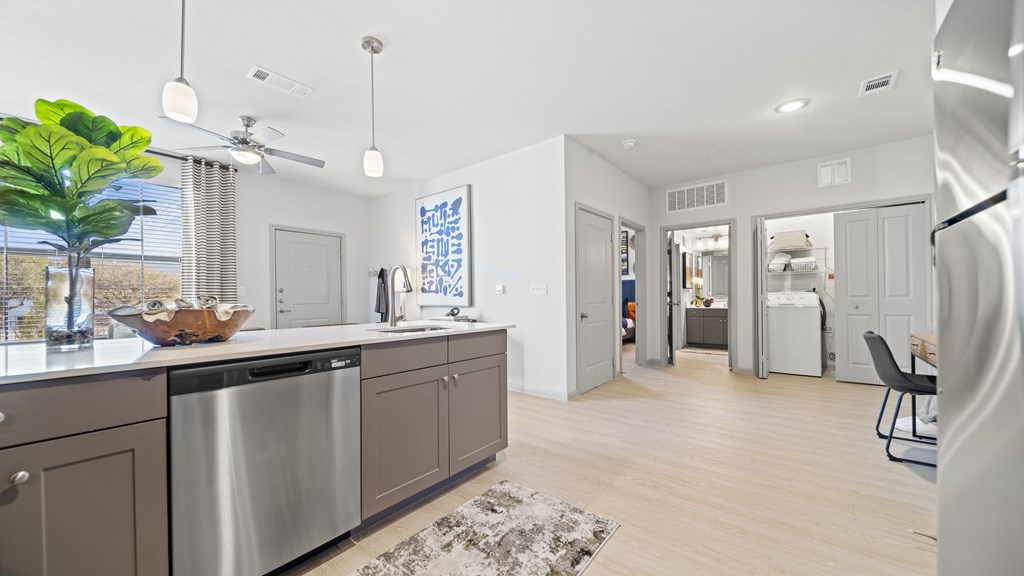 a kitchen with stainless steel appliances and a large counter top