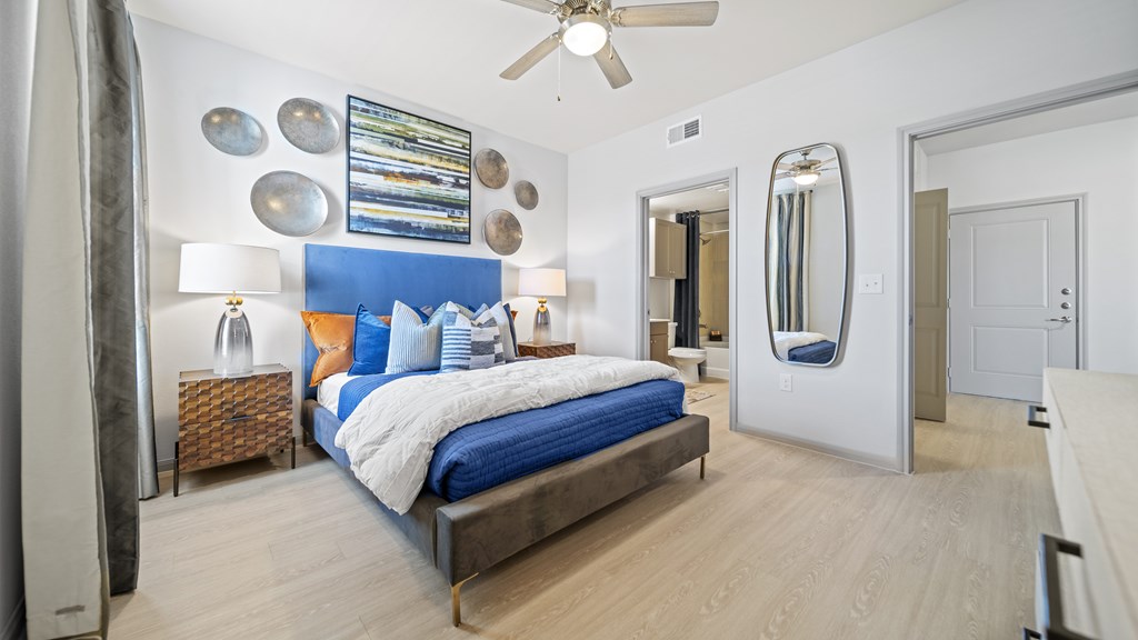 a bedroom with a bed and a ceiling fan