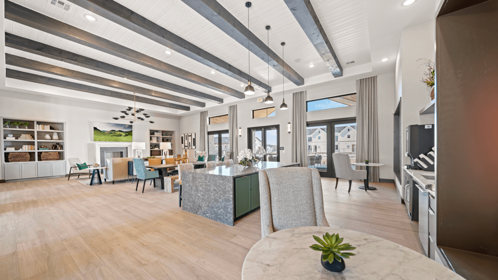 a large living room with a dining room table and chairs