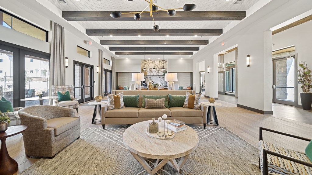 a living room with couches and chairs and a table