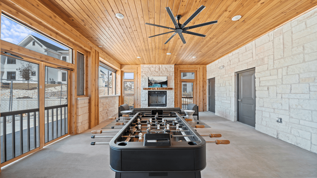 the home has a large game room with a bar and a fireplace