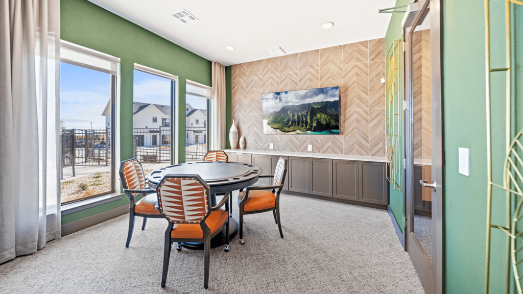 a dining room with a table and chairs