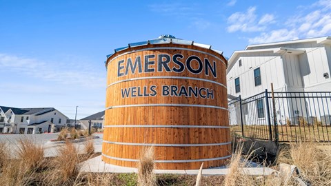 a barrel with the words on it in front of a house