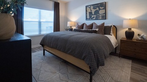 Primary bedroom with king size bed and large window.