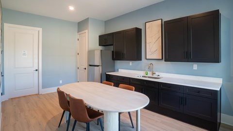 A kitchen with a table and chairs in the middle of the room.