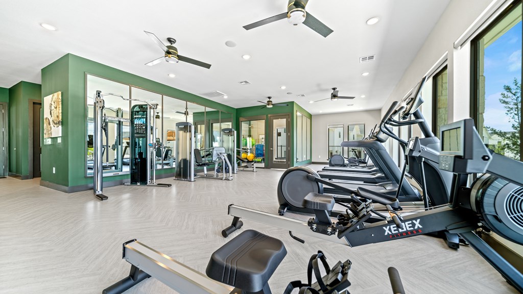 a gym with treadmills and other exercise equipment