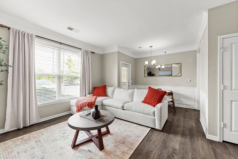 A living room with a white couch and a coffee table.