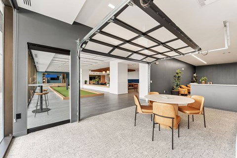 A modern dining room with a glass door leading to a balcony.