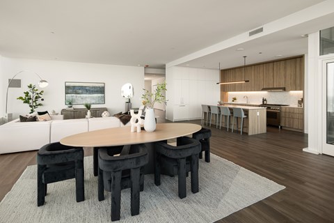 A modern dining room with a wooden table and chairs.
