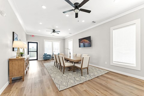 A dining room with a wooden table and chairs.