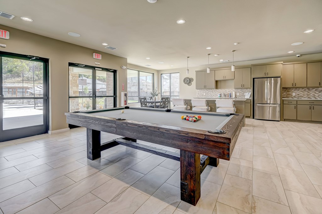 Pool table in resident clubhouse with entertainment kitchen