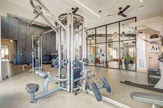 a workout room with a lot of exercise equipment