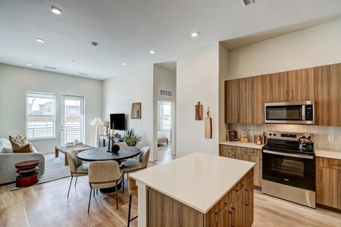 A modern kitchen with wooden cabinets and stainless steel appliances.