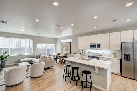 A modern kitchen with white cabinets and stainless steel appliances.