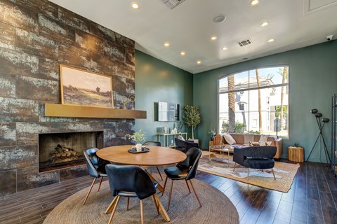 A living room with a fireplace and a painting on the wall.