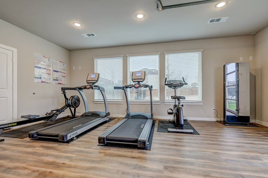 State-of-the-art fitness center with treadmill and fitness mirror