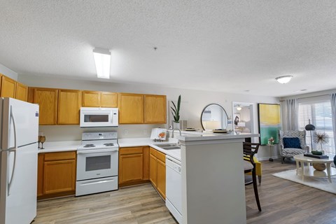 A kitchen with wooden cabinets and white appliances.