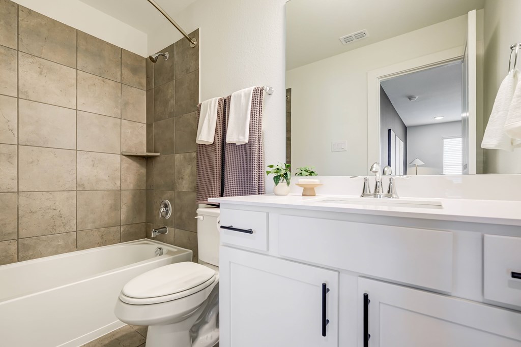 a bathroom with a bathtub toilet and sink