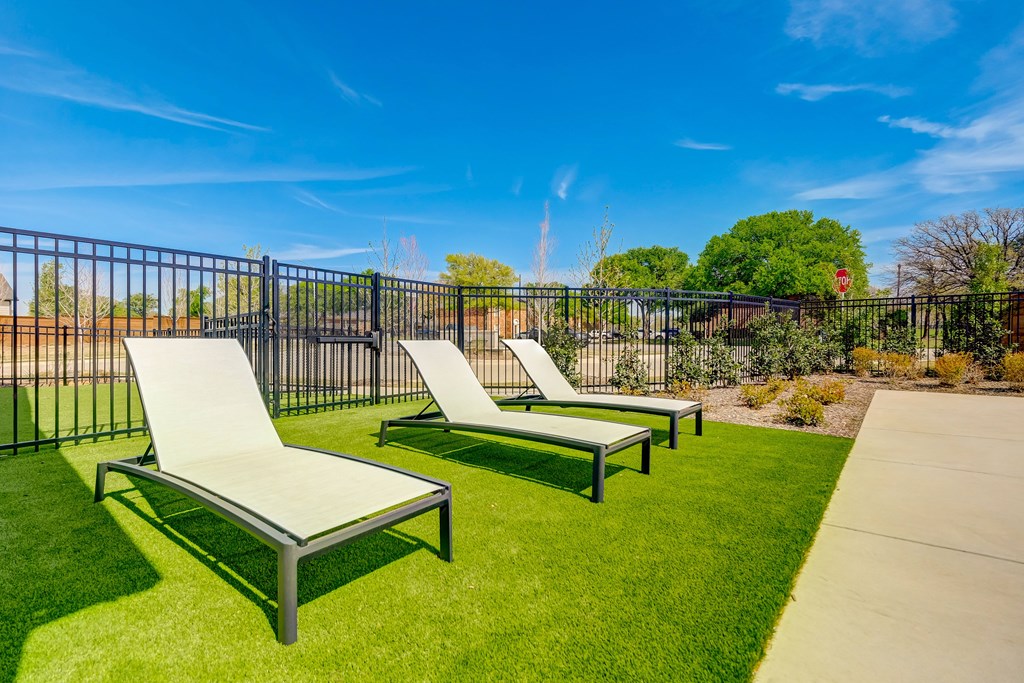 Poolside lounge chairs with outdoor yard