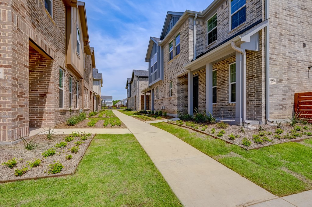 a row of houses on a grassy street