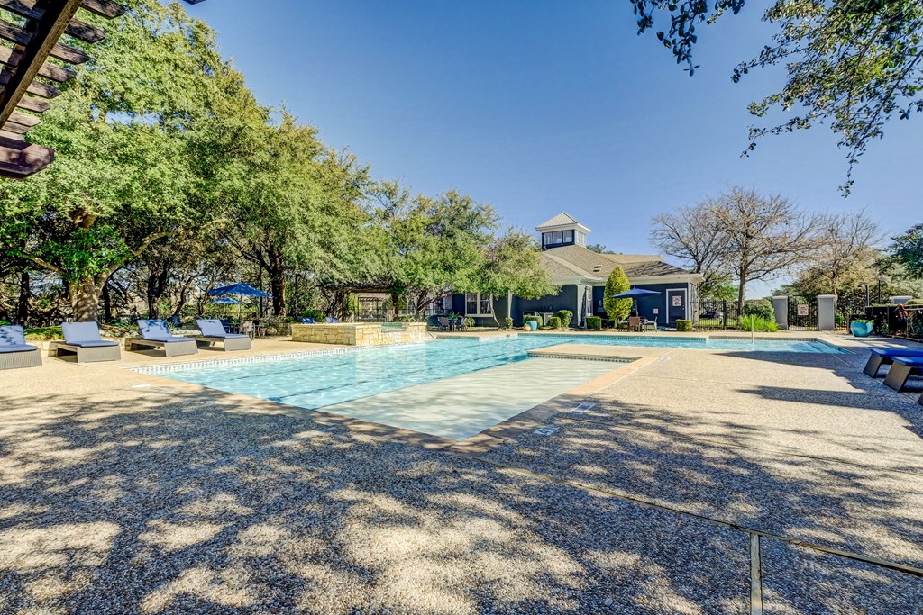 Pool area with poolside seating, loungers, grills, and cabanas