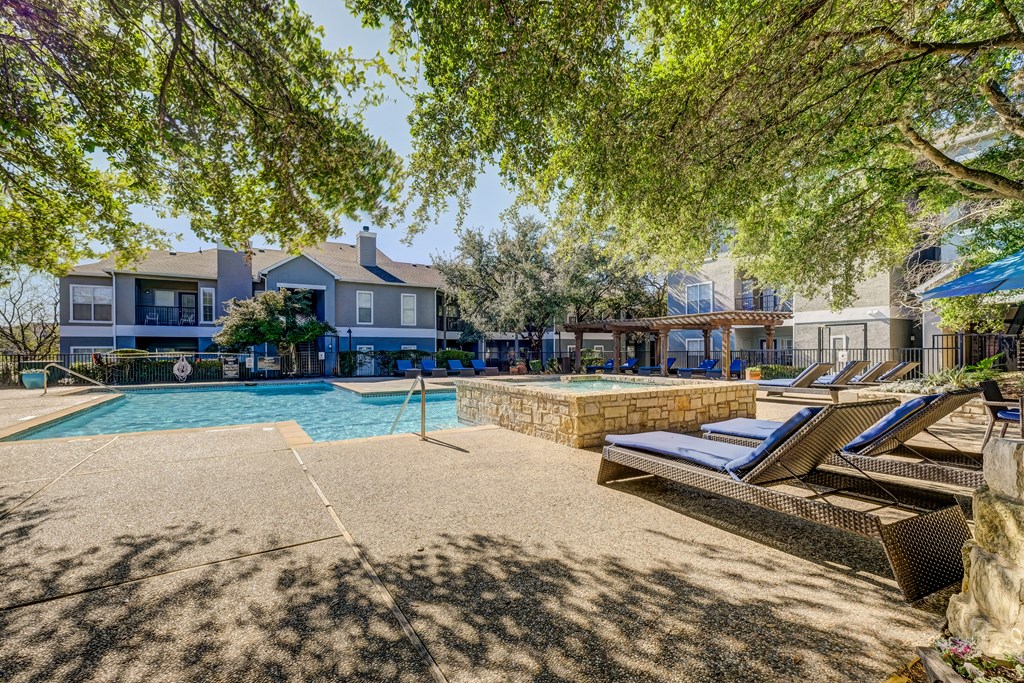 Pool with poolside loungers, Grilling area, and cabanas