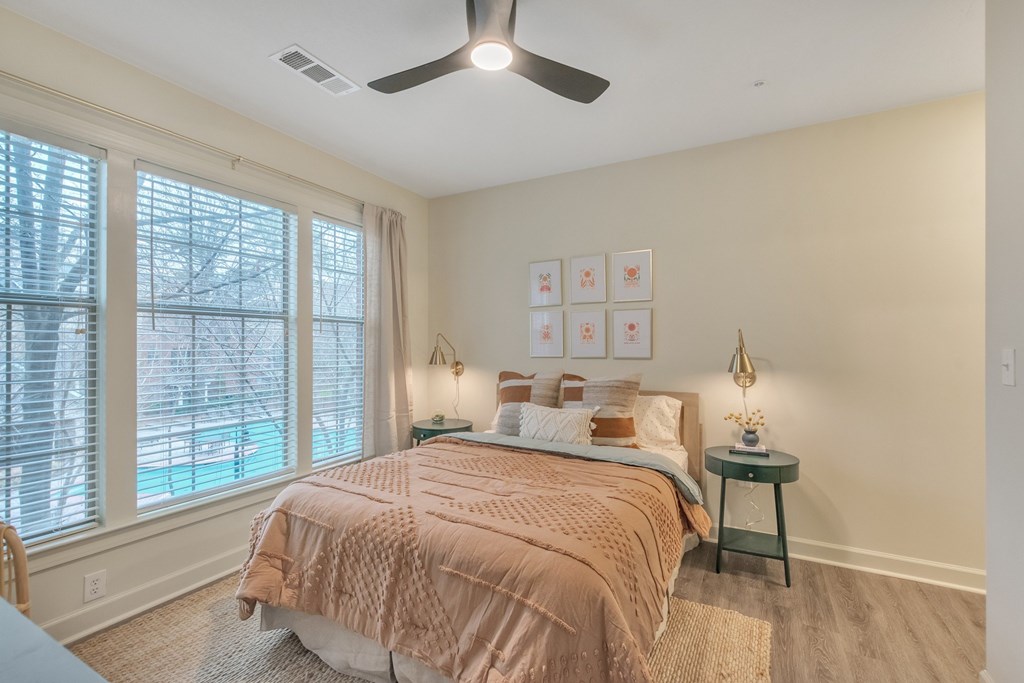a bedroom with a bed and a ceiling fan
