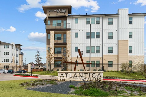 The Atlantica Atalamo building is a modern multi-story structure with a prominent entrance sign.