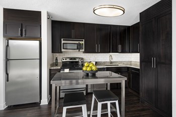 Kitchen with espresso cabinets and stainless steel appliances - Photo Gallery 3