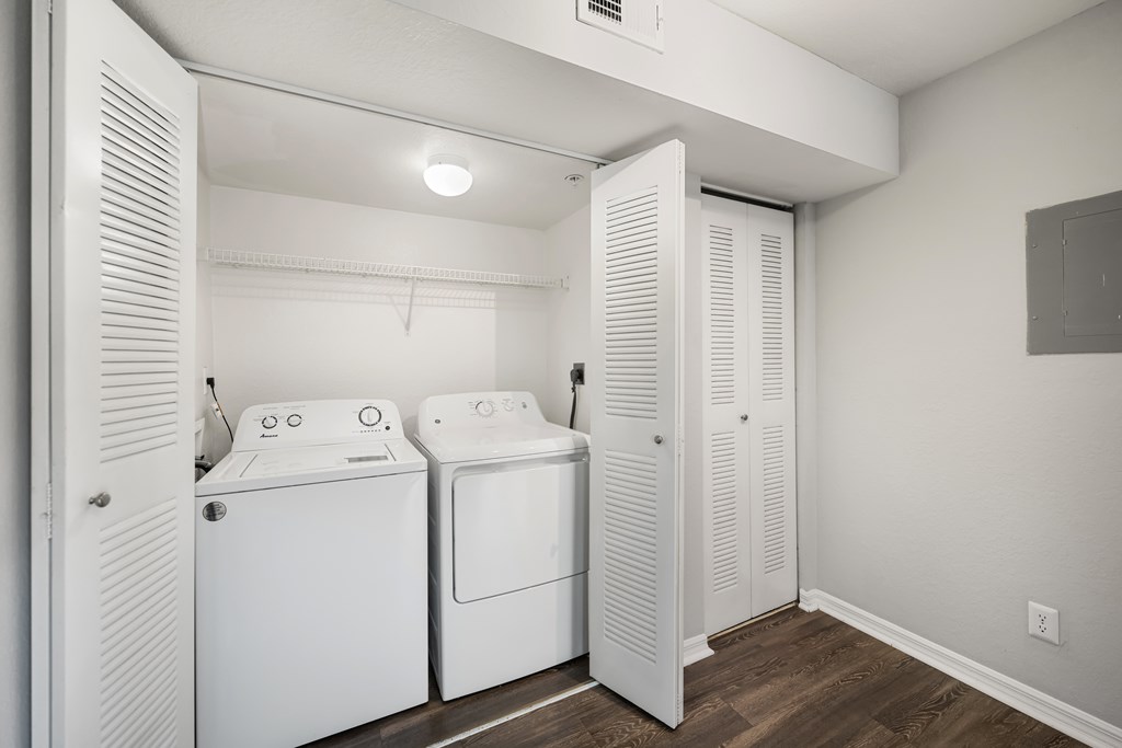 a spacious laundry room with two washes and a dryer