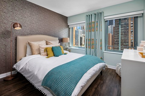 a bedroom with a bed and two windows