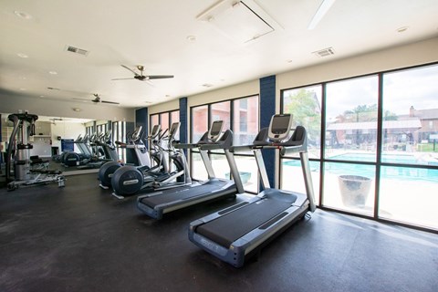 A gym with treadmills and other exercise equipment.