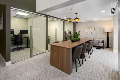 A conference room with a long table and chairs.