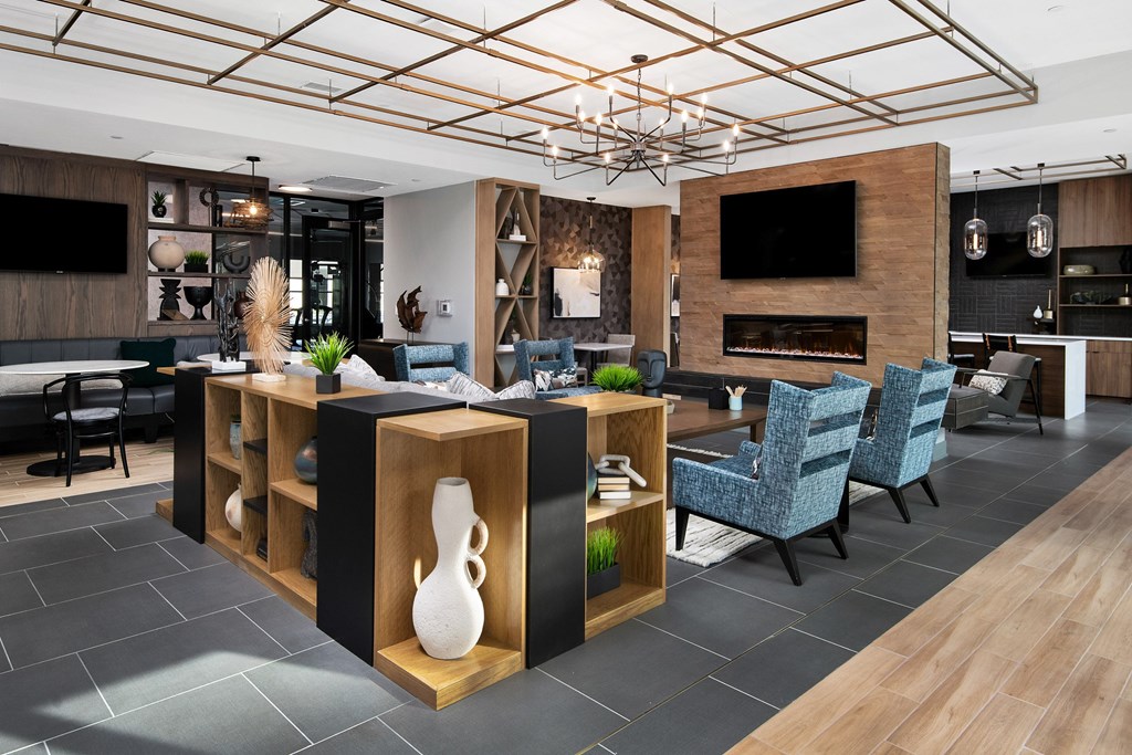 the lobby of a hotel with a dining area and a living room