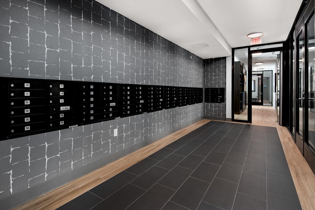 a hallway with black tiles and a wall with rows of equations on it