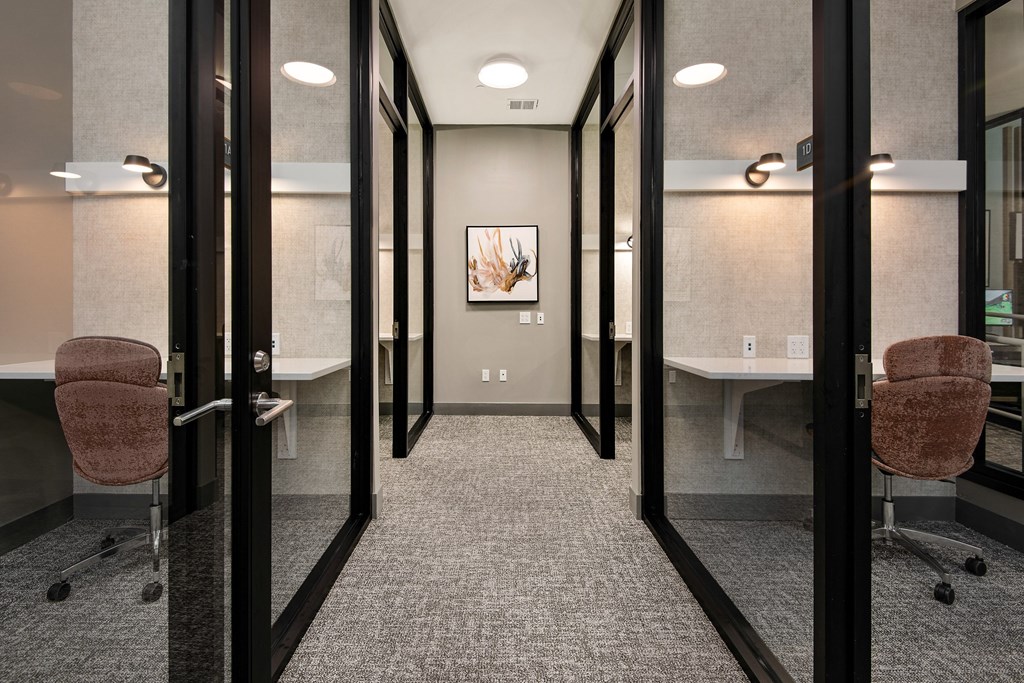 a conference room with chairs and tables and mirrored doors