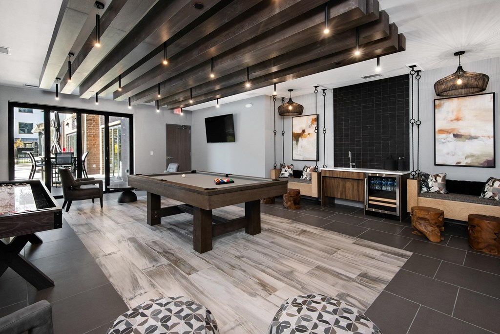 a game room with a pool table and a tv