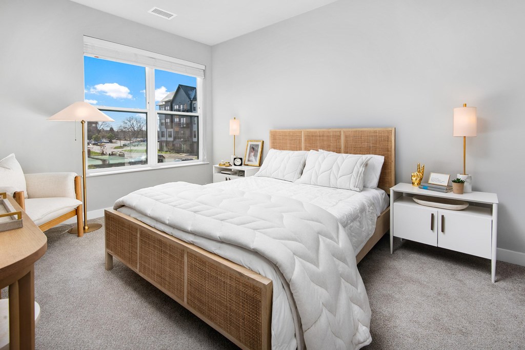 a bedroom with a large bed and a window