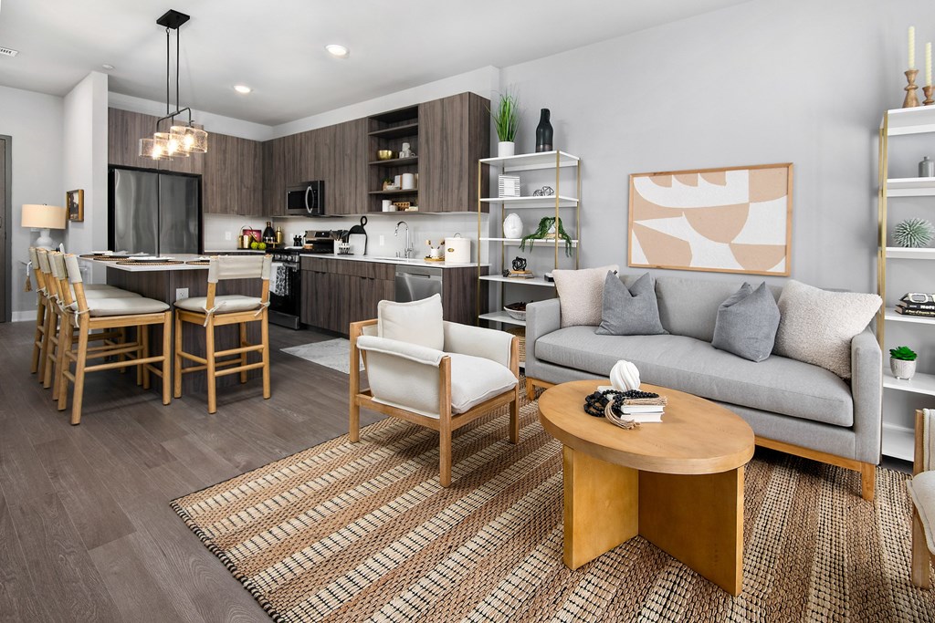 a living room and kitchen with a couch and a table